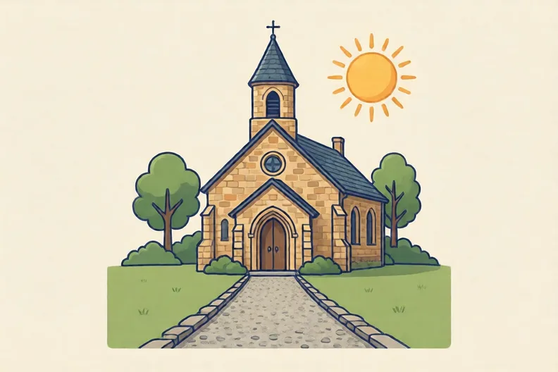 A stone village church with a gravel path leading towards it on a sunny day
