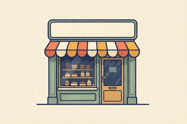 A plain empty shop sign above a bakery door on a sunny street