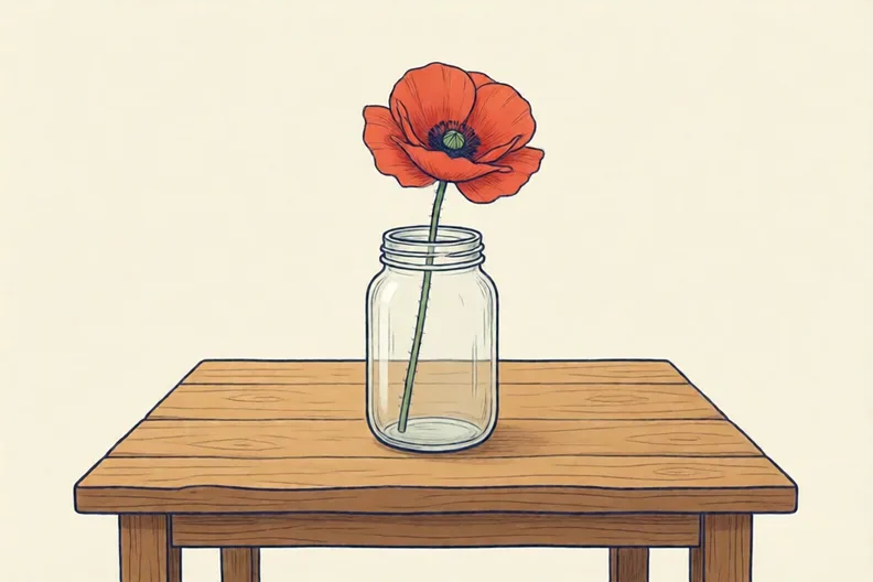 A single red poppy in a plain glass jar on a wooden table