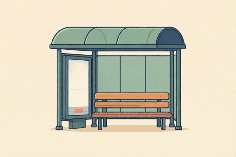 A bus stop with a bench and an empty advert panel, no people