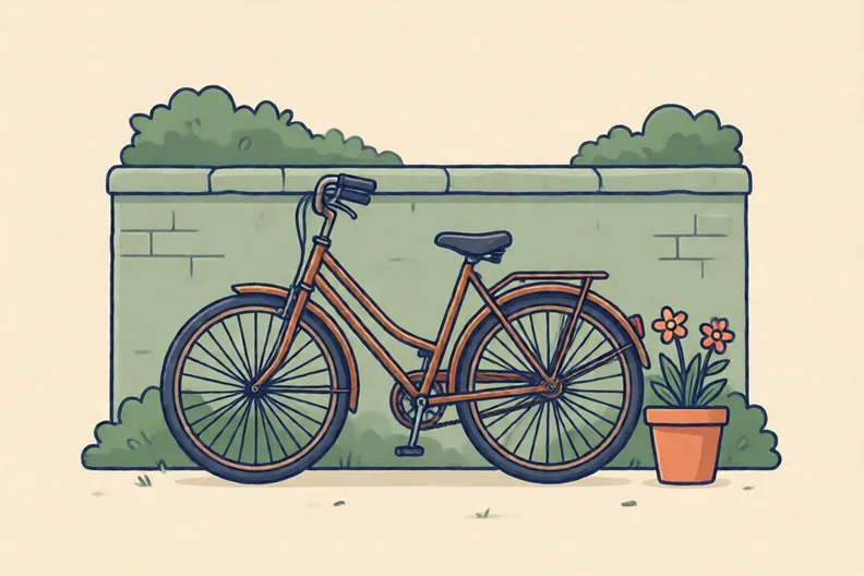 A rusty old bicycle leaning against a garden wall
