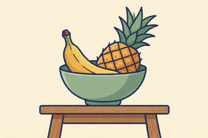 A bowl with a banana and a pineapple on a wooden table