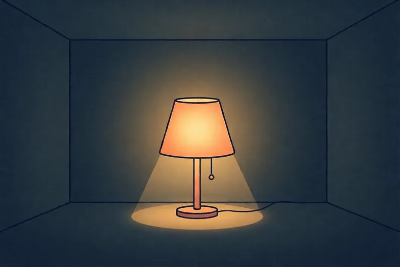 A single lamp glowing in a dark room, with nothing else beside it