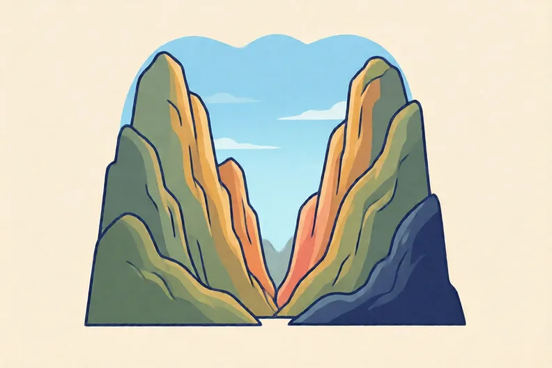 Two tall mountains with a narrow gap between them under a clear sky