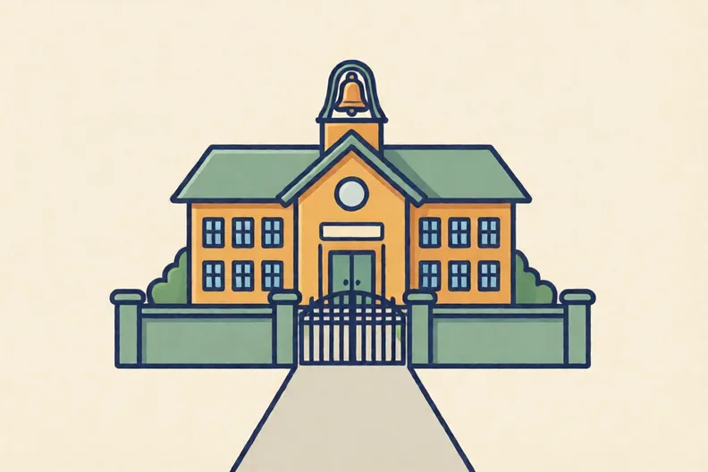 A school building with a bell on its roof, a low gate, and a path leading in.