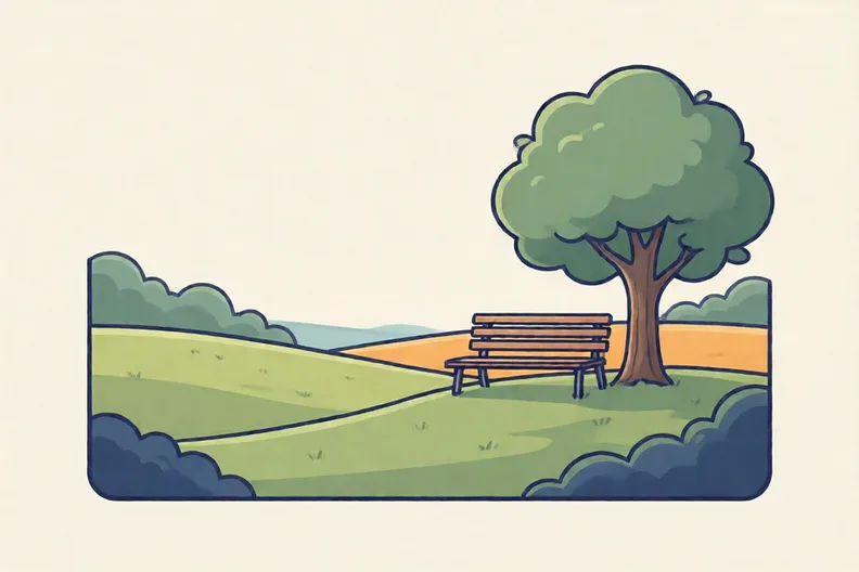 An open grass field with a tree and a bench at the edge