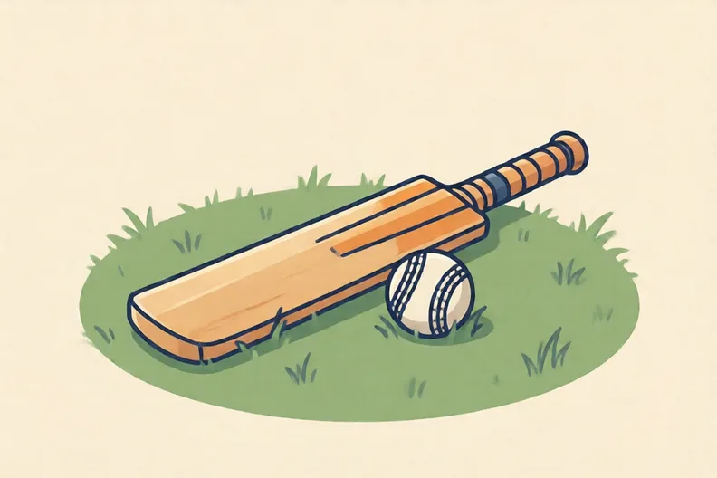 A cricket bat and a soft ball resting on a grass lawn