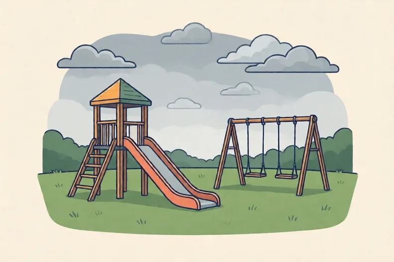 An empty playground under a grey cloudy sky