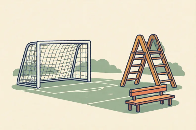 An empty school playground with a football goal and a climbing frame