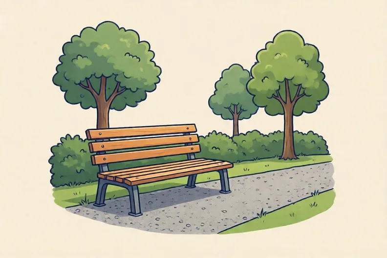 An empty park bench beside a path under green trees
