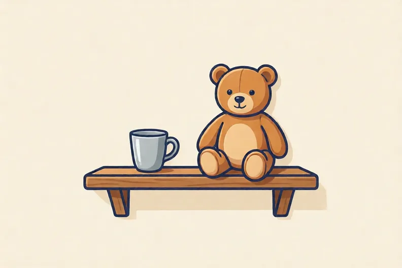A small silver cup and a soft toy on a wooden shelf
