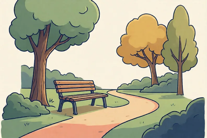An empty park bench beside a small green lawn and a tree
