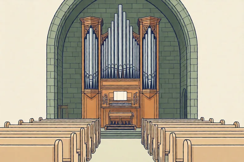 A pipe organ with tall silver pipes inside a stone church