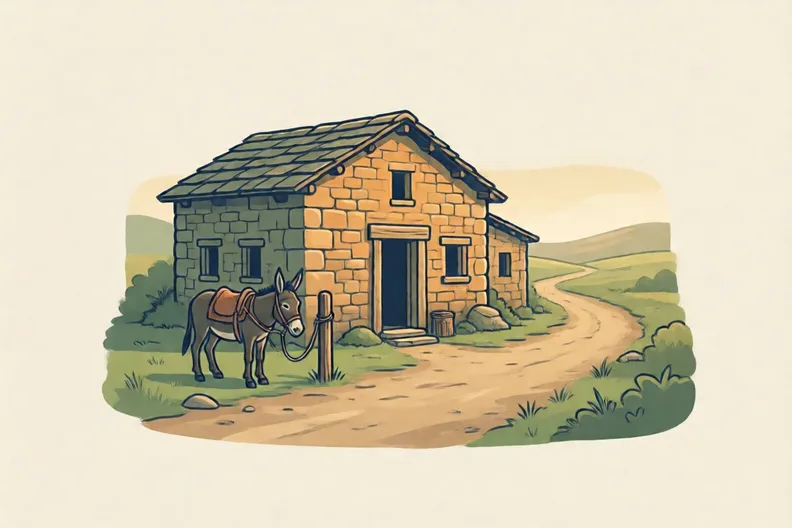 A simple stone inn beside a dusty road, with a donkey tied outside