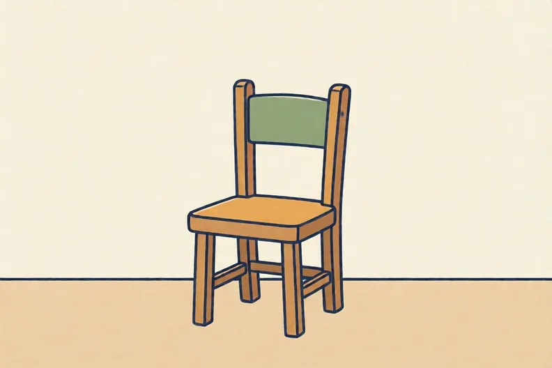 A wooden chair standing against a plain wall